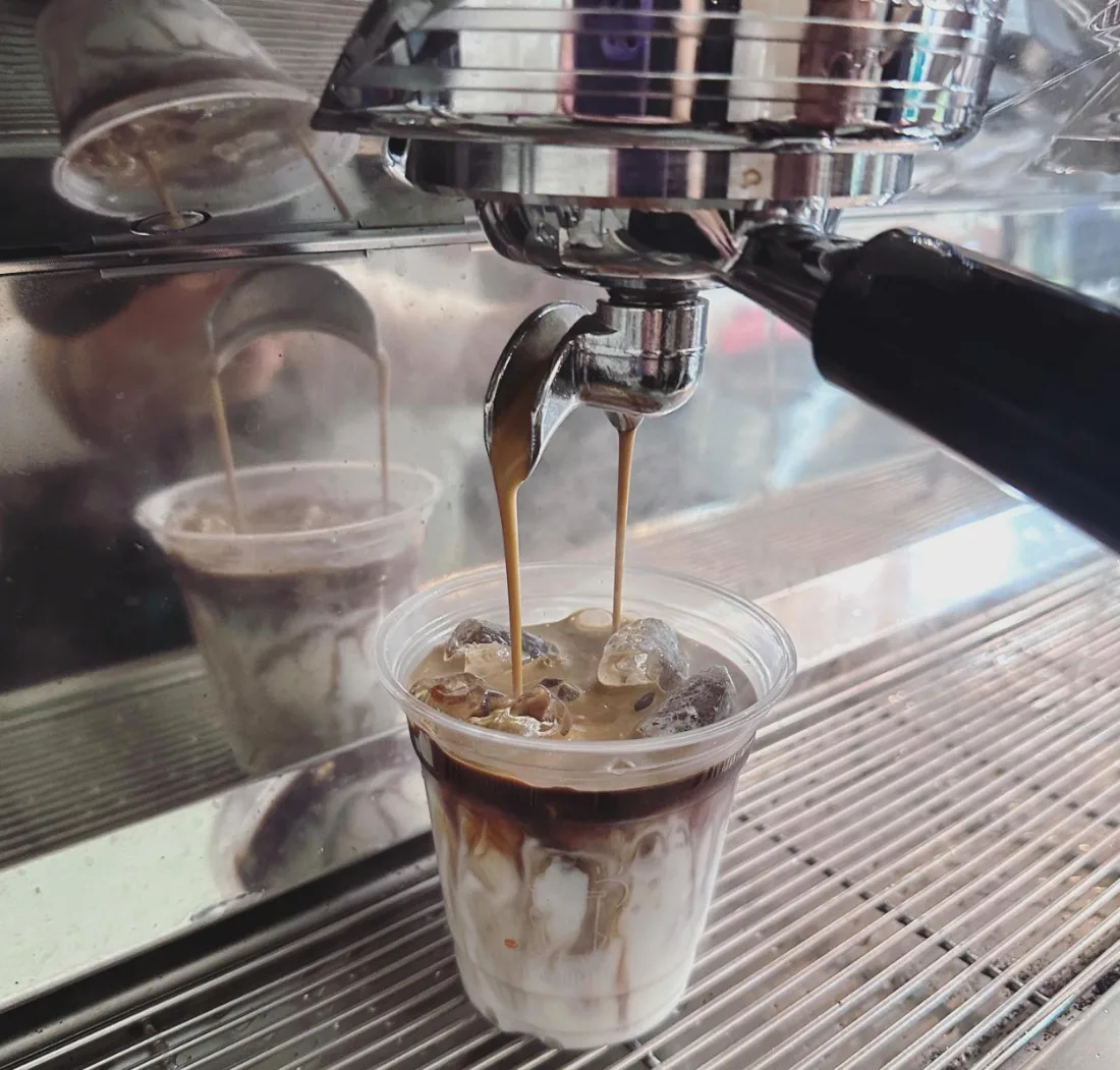 A double shot of espresso pulled straight over milk and ice on Daylight Coffee&rsquo;s Nuova Simonelli